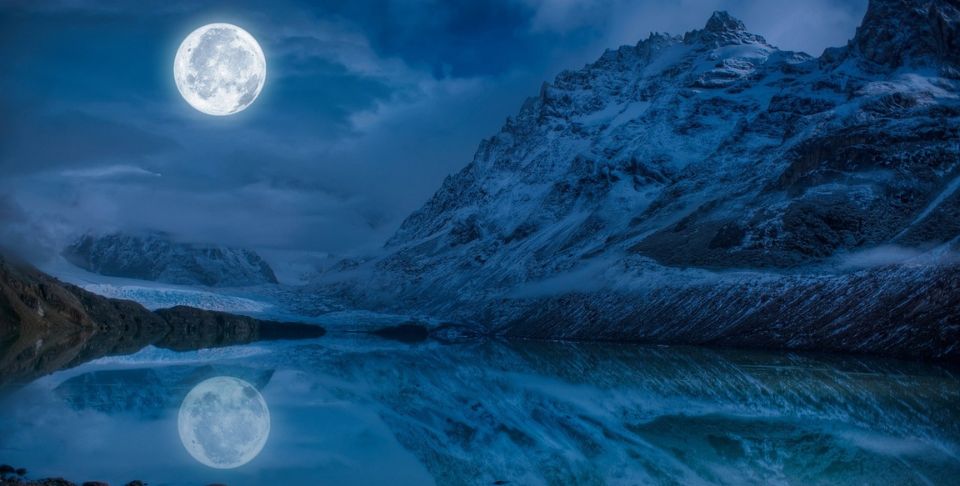 full moon reflected on a mountain-top lake, moon spiritual meaning