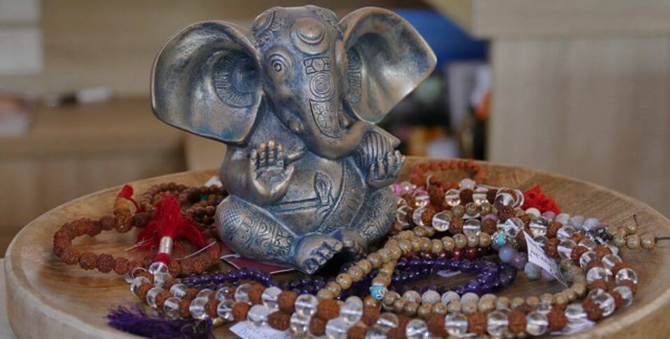 statue of Ganesh seated surrounded by spiritual stones