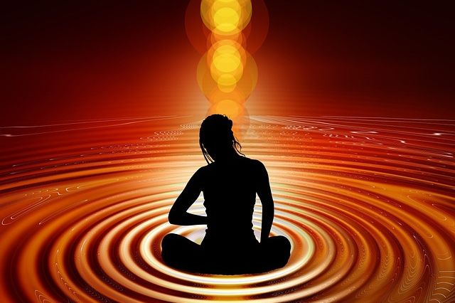 woman meditating with vibratory energy, connection to the spiritual universe