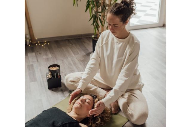 woman performing an energetic treatment on a patient